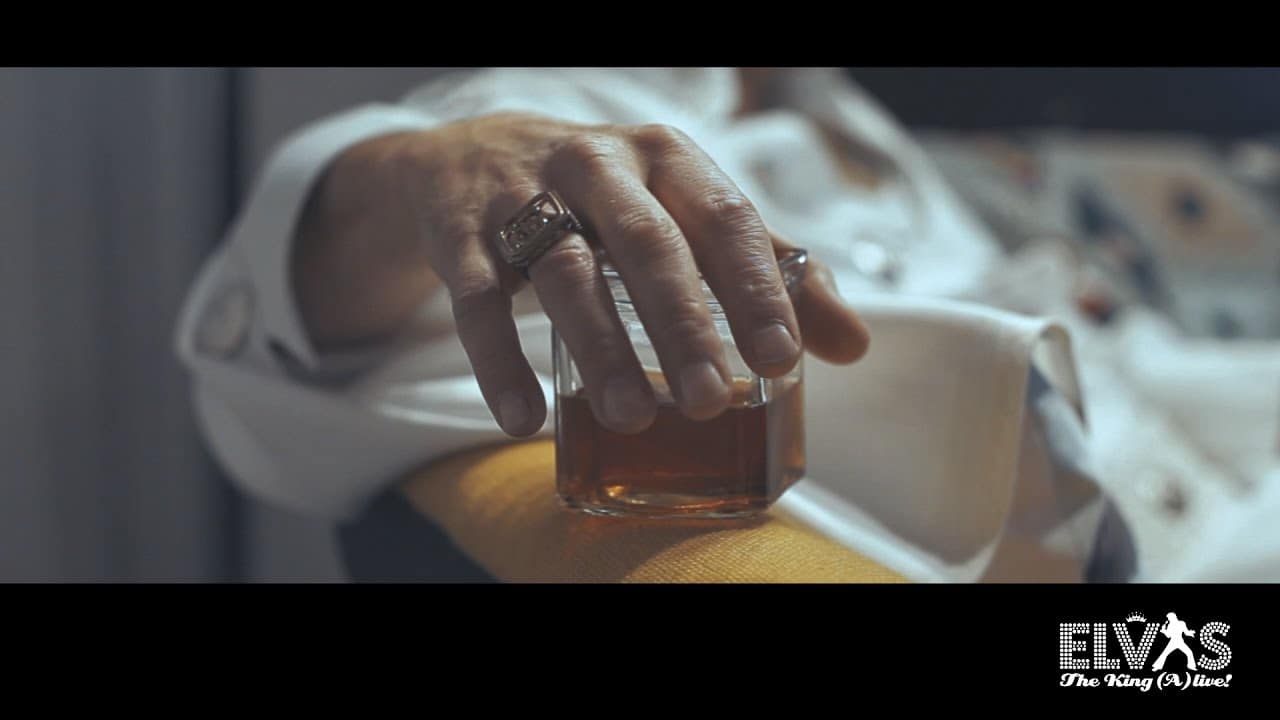 Sipping from his cognac, relaxing in his home 